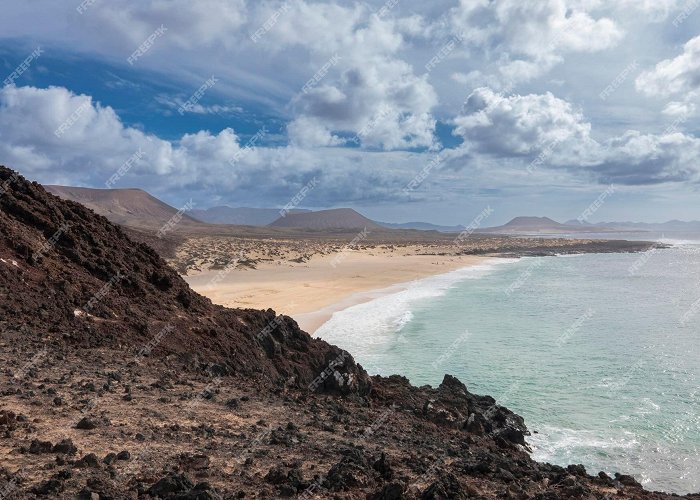 playa de famara Premium Photo | Cliffs and pristine beaches on the island of la ... photo