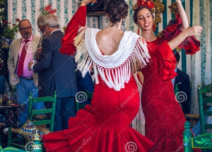 Feria de Abril de Sevilla Young and Beautiful Women Wearing Flamenco Dresses and Dancing ... photo